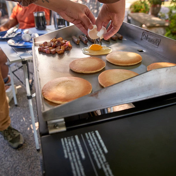 Coleman RoadTrip Griddle, 19/24 Propane Griddle with Instastart Ignition, Even Heat Distribution, Grease Tray & Optional Lid; Portable Griddle with Scissor Legs & Wheels for Camping & Tailgating